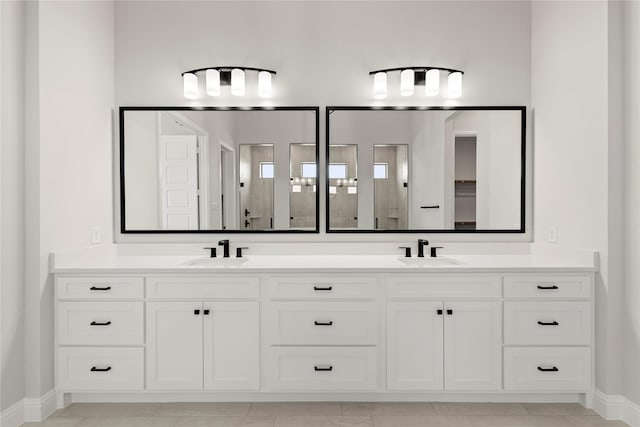 bathroom featuring a closet, a sink, and double vanity