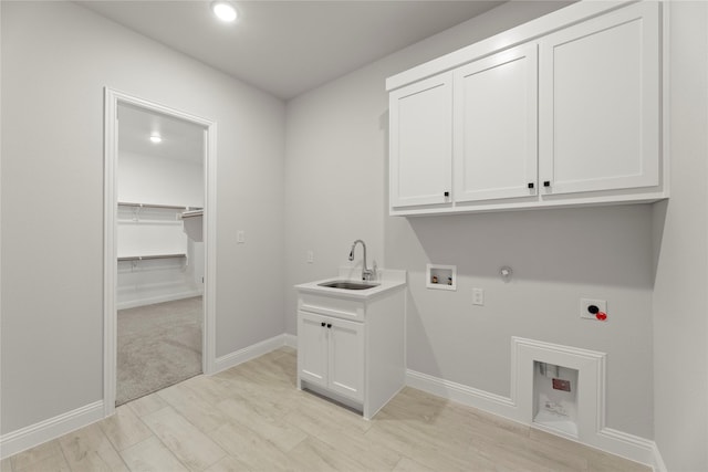 laundry room featuring cabinet space, hookup for a gas dryer, a sink, hookup for a washing machine, and electric dryer hookup