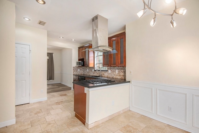 kitchen with sink, tasteful backsplash, island range hood, kitchen peninsula, and stainless steel appliances