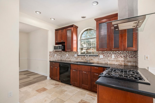 kitchen featuring sink, black appliances, island exhaust hood, decorative backsplash, and dark stone counters