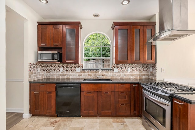 kitchen featuring appliances with stainless steel finishes, range hood, sink, backsplash, and dark stone counters