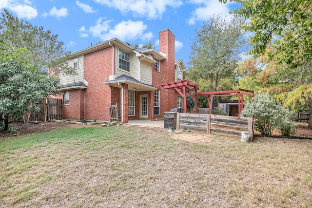 rear view of property featuring a yard, a patio area, and a pergola