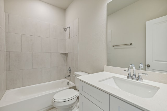 full bathroom featuring vanity, tiled shower / bath combo, and toilet