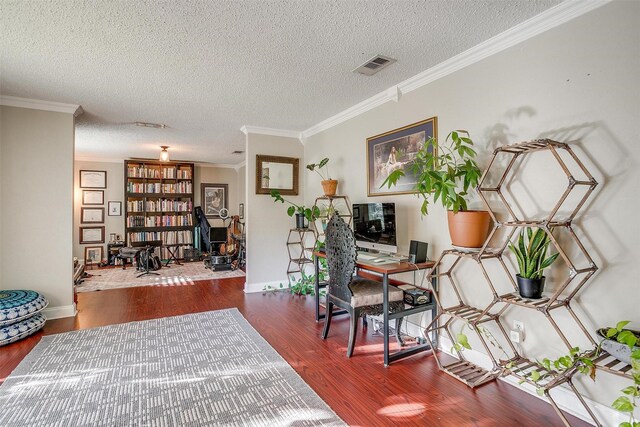 foyer entrance with a textured ceiling, dark hardwood / wood-style floors, and ornamental molding