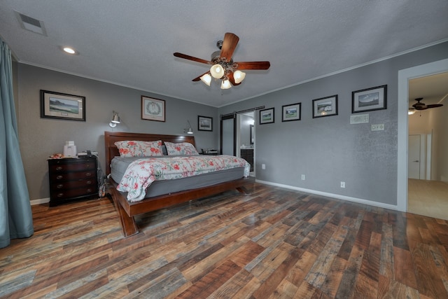 bedroom with dark wood-type flooring, ceiling fan, ornamental molding, and a textured ceiling