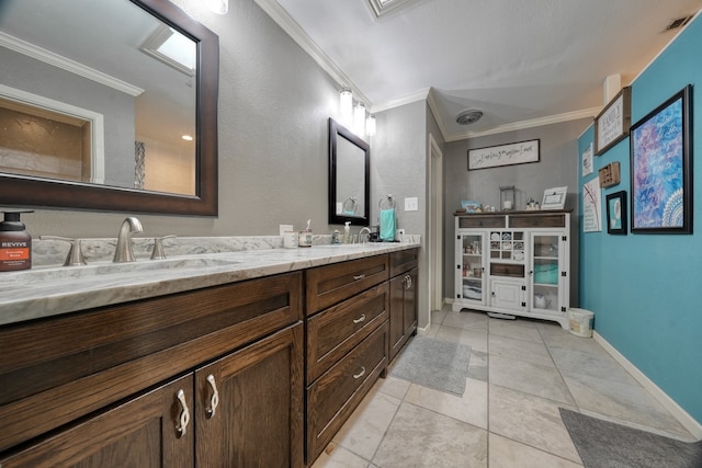 bathroom with vanity, ornamental molding, and tile patterned floors