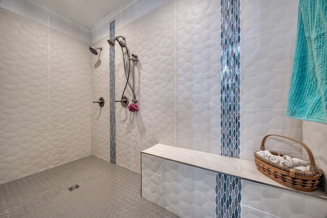 bathroom featuring a tile shower and ornamental molding