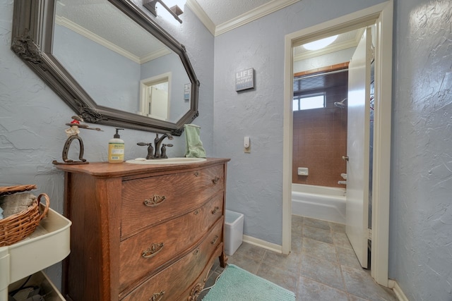 bathroom with vanity, crown molding, a textured ceiling, and tiled shower / bath