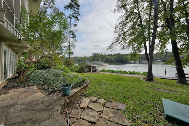 view of yard with a water view and a patio area