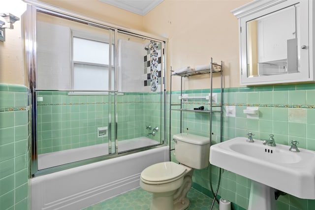 full bathroom featuring toilet, enclosed tub / shower combo, tile walls, and ornamental molding