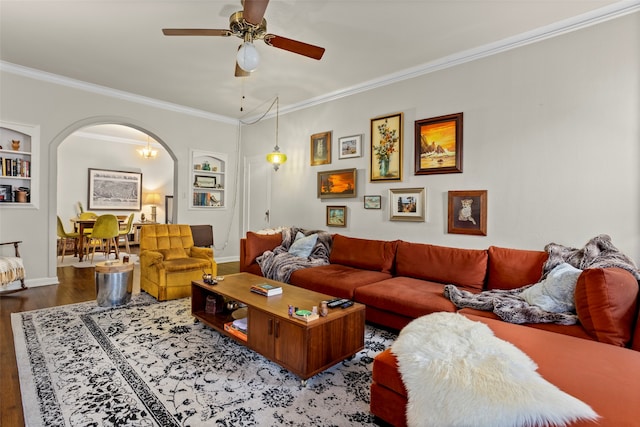 living room with ceiling fan, hardwood / wood-style flooring, ornamental molding, and built in features