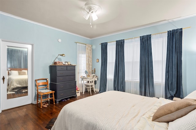 bedroom with dark hardwood / wood-style flooring, ornamental molding, and ceiling fan