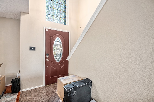 entryway with a textured ceiling and plenty of natural light