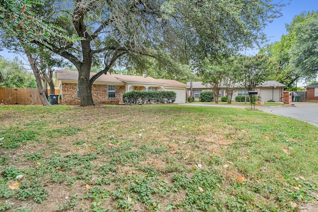 ranch-style home featuring a front yard and a garage