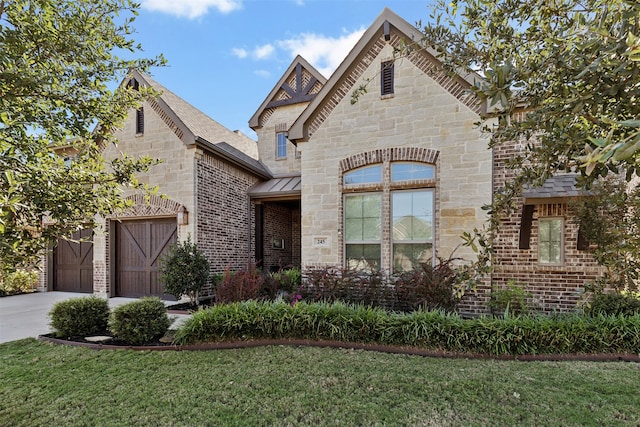 view of front of property with a garage and a front lawn