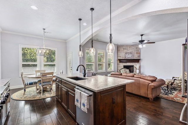 kitchen featuring a wealth of natural light, decorative light fixtures, and dark hardwood / wood-style flooring