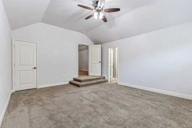 interior space featuring carpet floors, ceiling fan, and vaulted ceiling