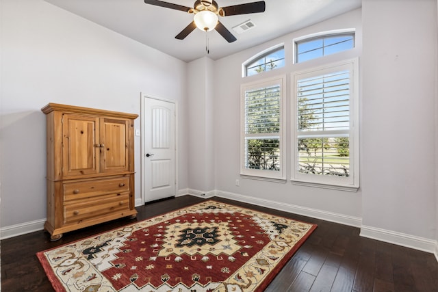 sitting room with dark wood-type flooring, ceiling fan, and vaulted ceiling