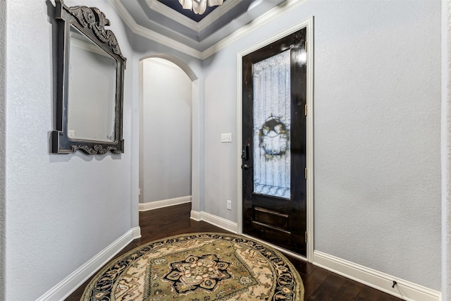 entryway with crown molding and dark wood-type flooring