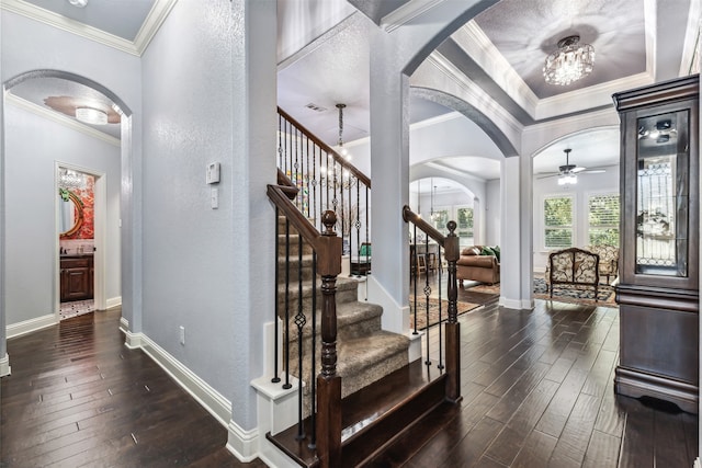 stairway with ornamental molding, hardwood / wood-style floors, and ceiling fan