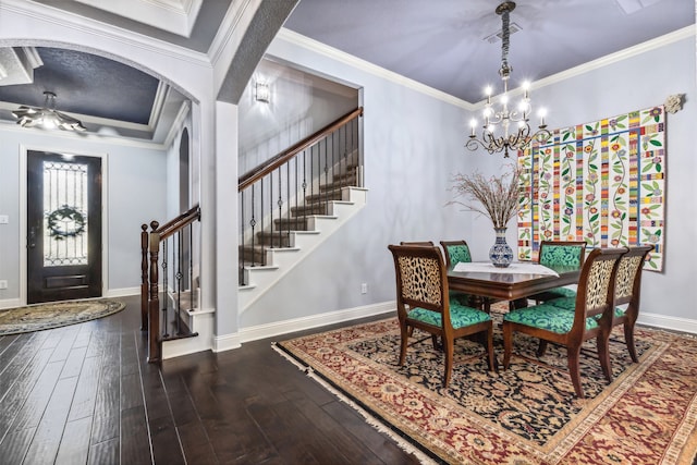 dining area with ornamental molding, a chandelier, and dark hardwood / wood-style flooring