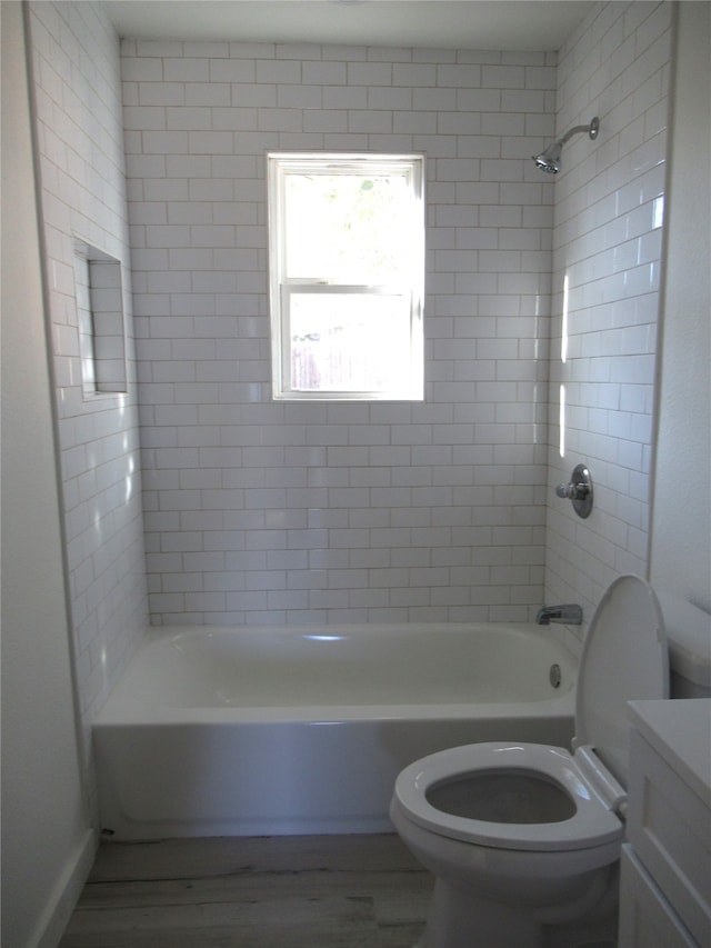 full bathroom with vanity, toilet, hardwood / wood-style floors, and tiled shower / bath