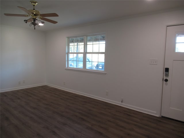 foyer entrance featuring ornamental molding, dark wood-type flooring, and ceiling fan