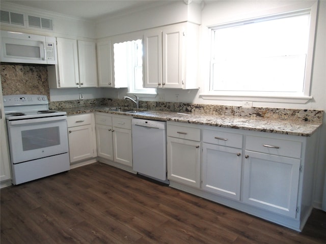 kitchen with white appliances, light stone counters, dark wood-type flooring, and white cabinets