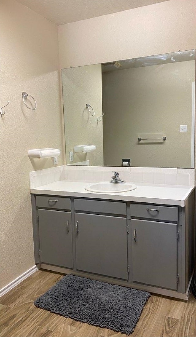 bathroom with vanity, hardwood / wood-style floors, and toilet