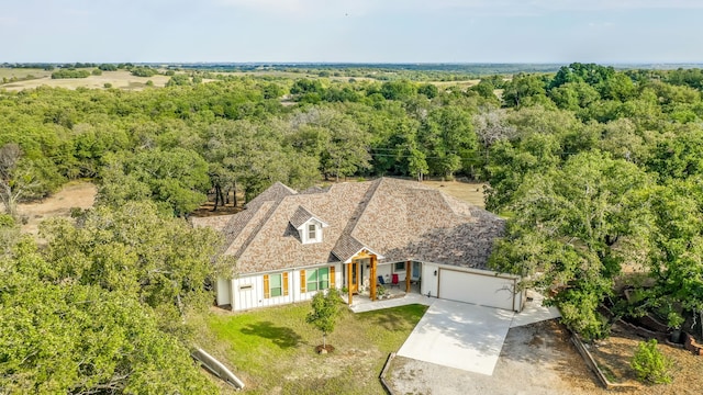 birds eye view of property with a wooded view