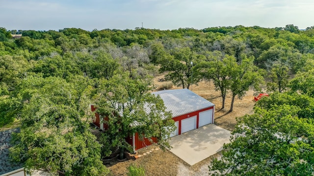 drone / aerial view with a wooded view