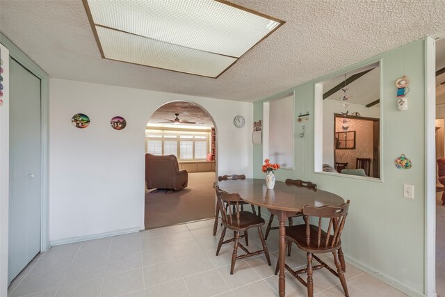 dining room featuring light tile patterned floors and a textured ceiling