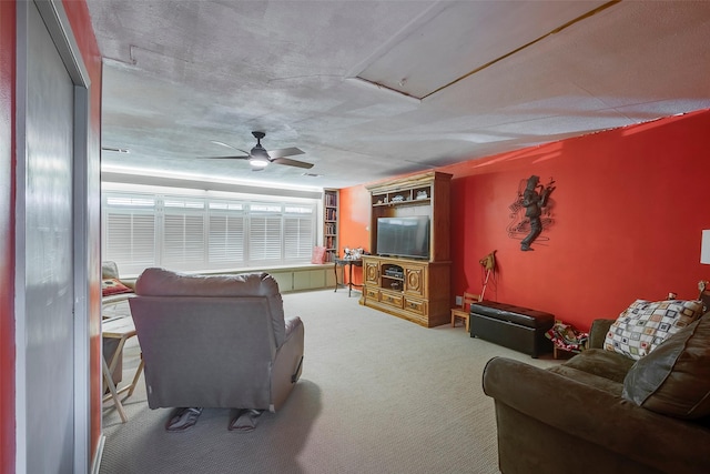 carpeted living room featuring ceiling fan