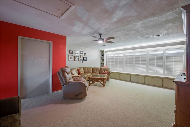 carpeted living room featuring ceiling fan