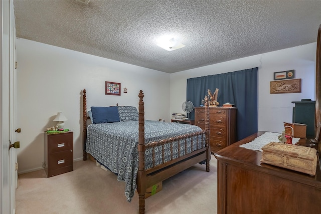 carpeted bedroom featuring a textured ceiling