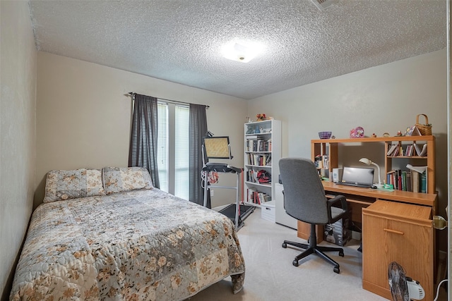 bedroom with light carpet and a textured ceiling