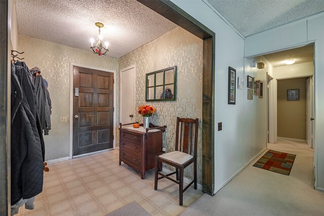 foyer featuring an inviting chandelier and a textured ceiling