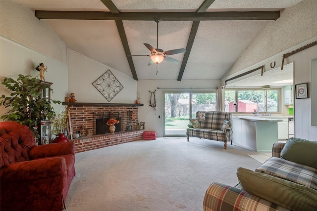 carpeted living room featuring a brick fireplace, vaulted ceiling with beams, a textured ceiling, and ceiling fan