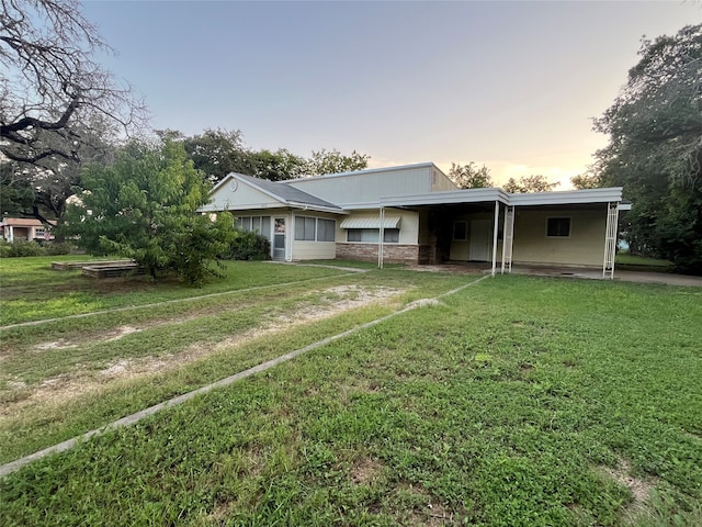 ranch-style home with a lawn