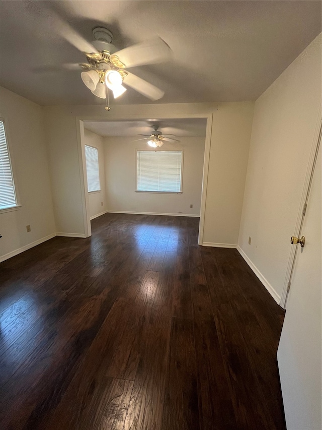 spare room featuring ceiling fan and dark hardwood / wood-style floors