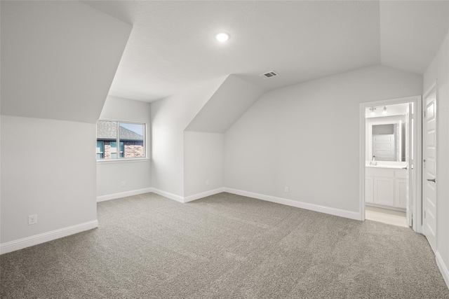 additional living space with lofted ceiling and carpet floors