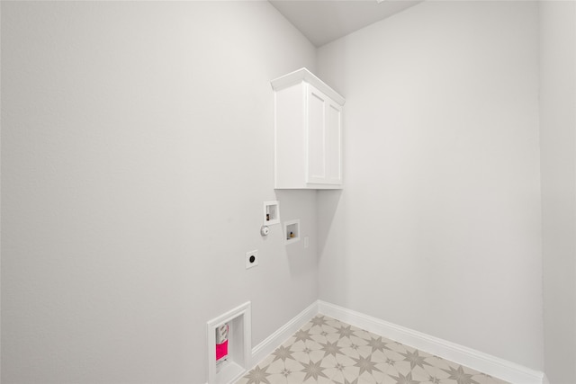 washroom with hookup for an electric dryer, washer hookup, and cabinets