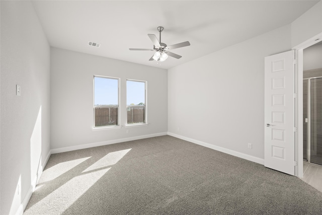 carpeted spare room featuring ceiling fan