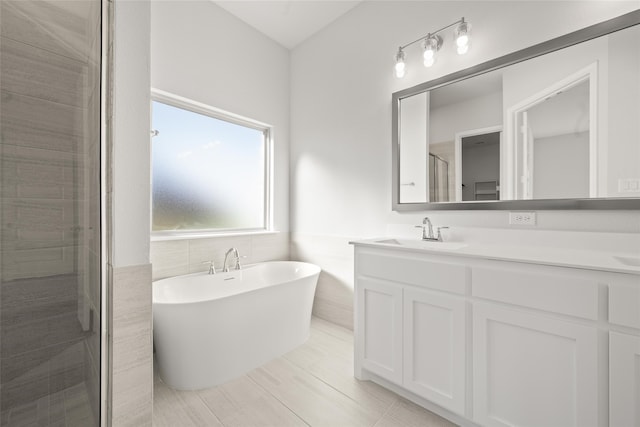 bathroom with tile patterned floors, vanity, tile walls, and independent shower and bath