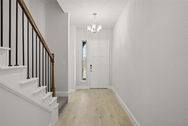 foyer featuring light hardwood / wood-style floors and a notable chandelier