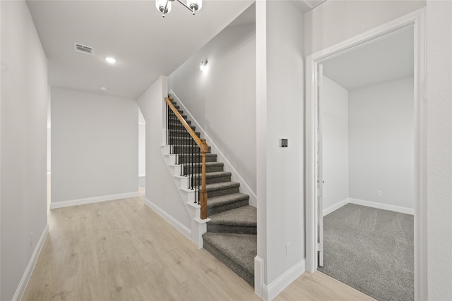 staircase with wood-type flooring