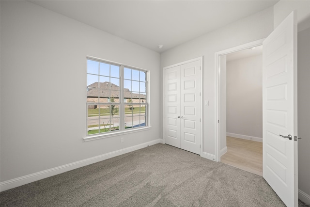 unfurnished bedroom featuring a closet and carpet floors