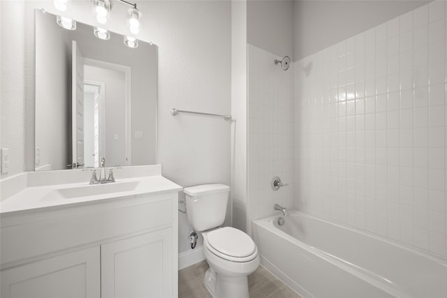 full bathroom featuring toilet, vanity, and tiled shower / bath