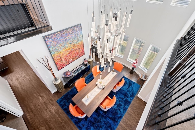 living room with dark hardwood / wood-style floors and a high ceiling