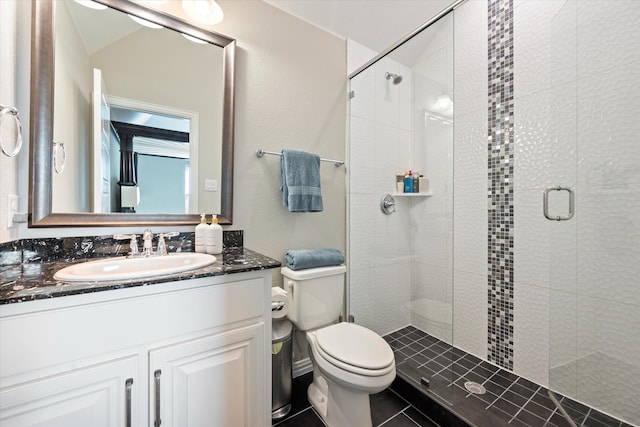 bathroom featuring vanity, toilet, tile patterned floors, and a shower with door